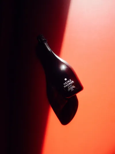 Heinz Wagner sparkling wine bottle without a paper label in red light