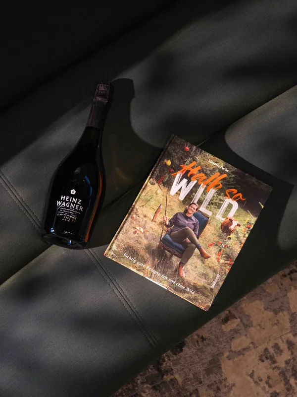Cookbook by Viktoria Fuchs next to a bottle of Heinz Wagner sparkling wine
