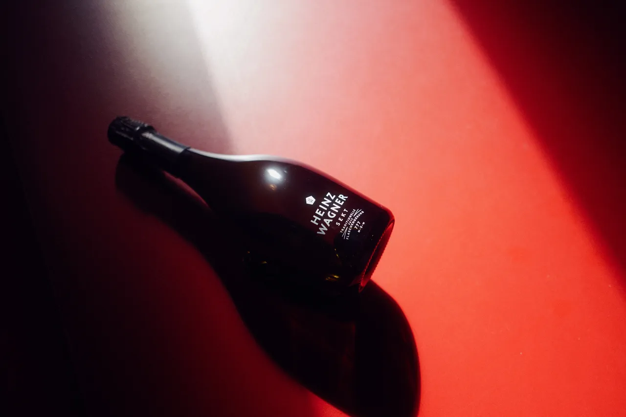 Heinz Wagner sparkling wine bottle lying in red light